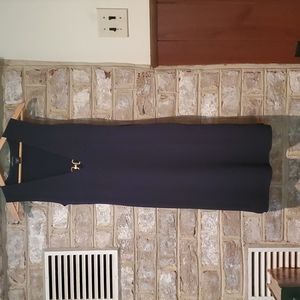 Navy form fitting polyester dress with gold embellishment at cleavage.